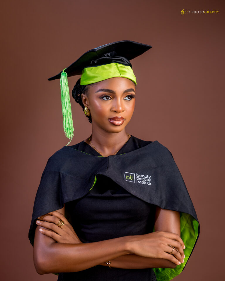 Ifedami at her international Aesthetician graduation, celebrating becoming a certified skincare professional.